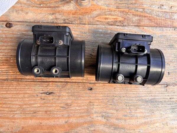 Connector side of OEM and aftermarket MAF sensors side by side