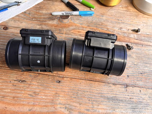 Side view showing the OEM FS1E E5T52271 part number sticker on the genuine sensor