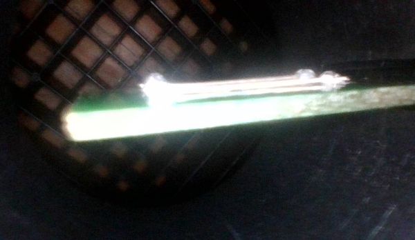 Close-up of the second aftermarket sensing element, showing a different construction on a green PCB substrate